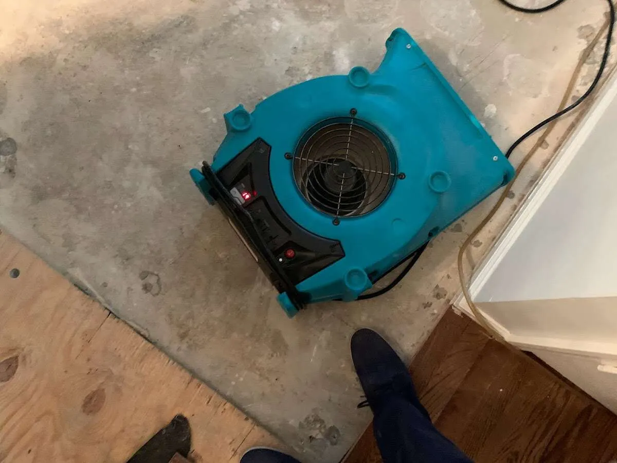 Air mover drying subfloor during Leak Detection & Repair in Providence